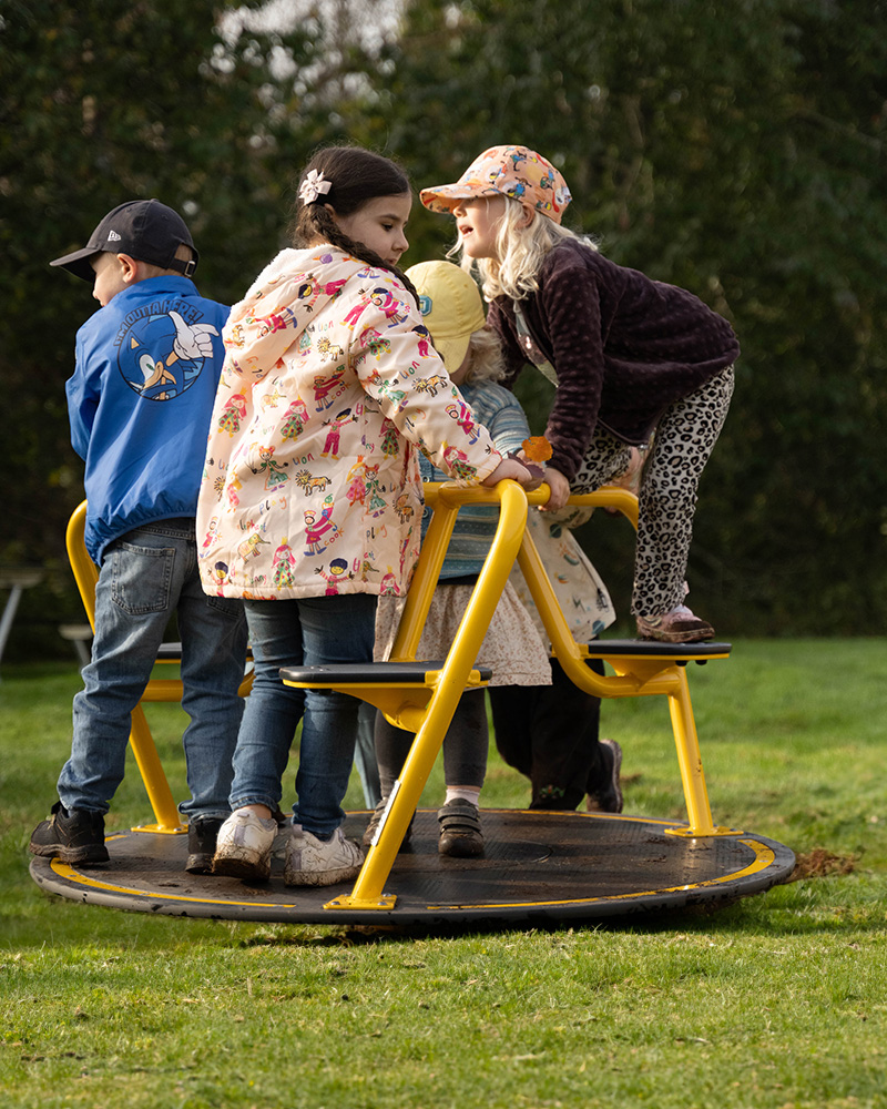 Kids spinning round and round on the Milly roundabout.